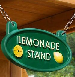 A green sign that says `` lemonade stand '' is hanging from a chain.
