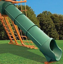 A green slide on a playground with a ladder attached to it.