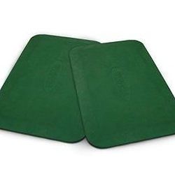 Two green coasters are sitting on top of each other on a white surface.