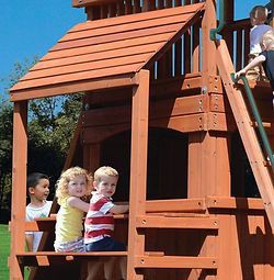 A group of children are playing on a wooden playground set.