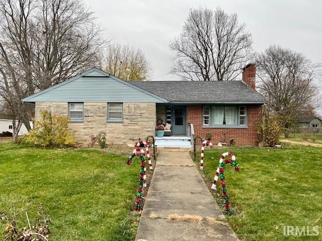 A brick house with a concrete walkway leading to it decorated with candy canes