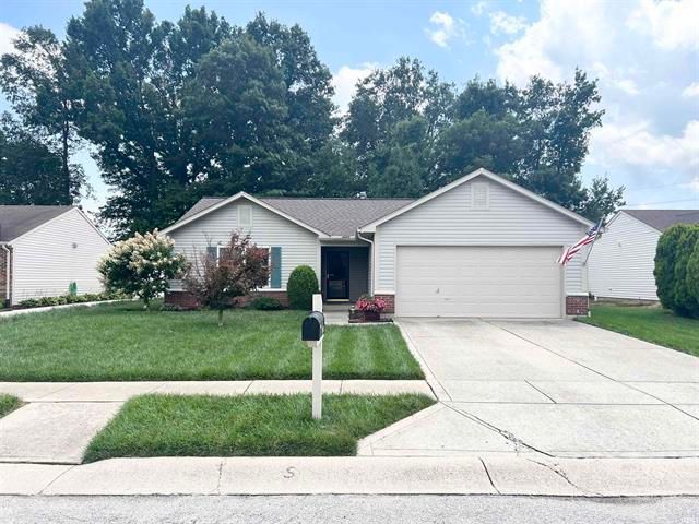 A white house with a mailbox in front of it