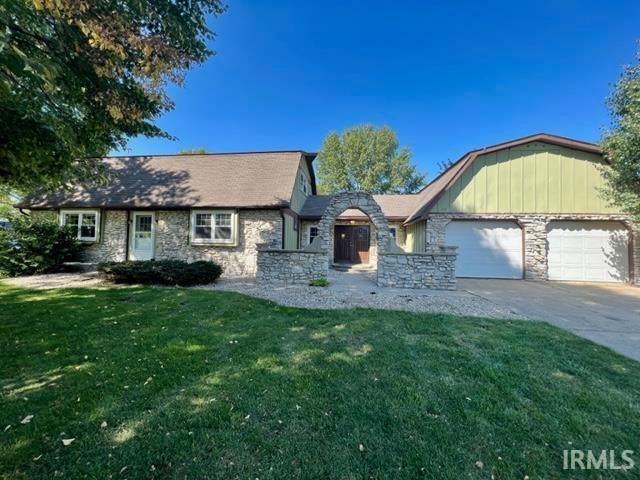 A house with a green roof is for sale