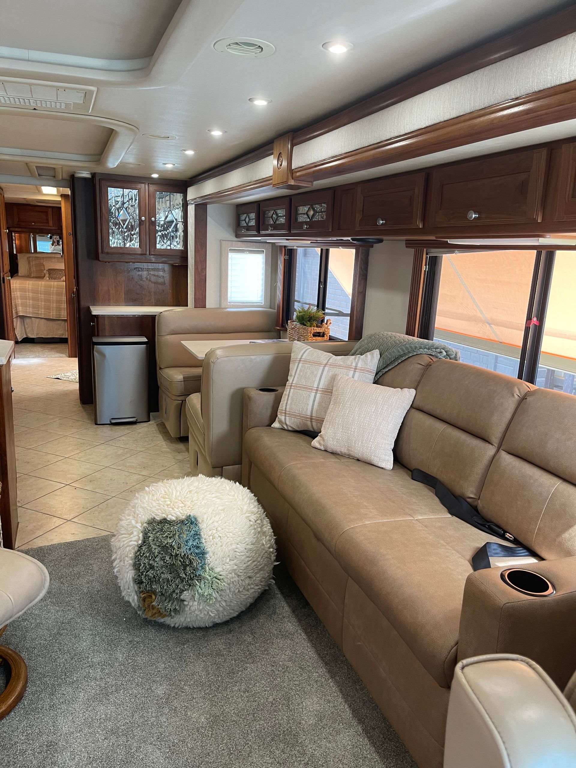 A living room in a rv with a couch and chairs.