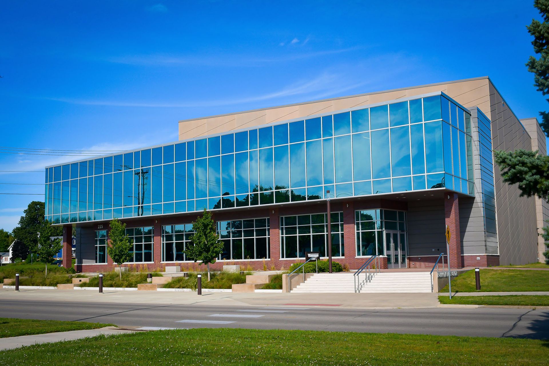 A large building with a lot of windows on a sunny day.