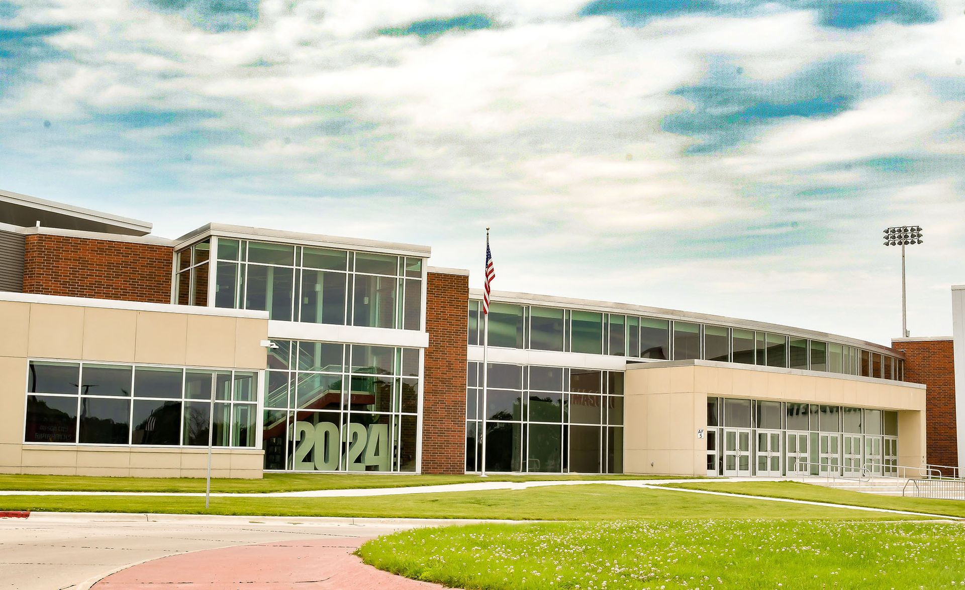 A large building with a lot of windows and a flag in front of it.