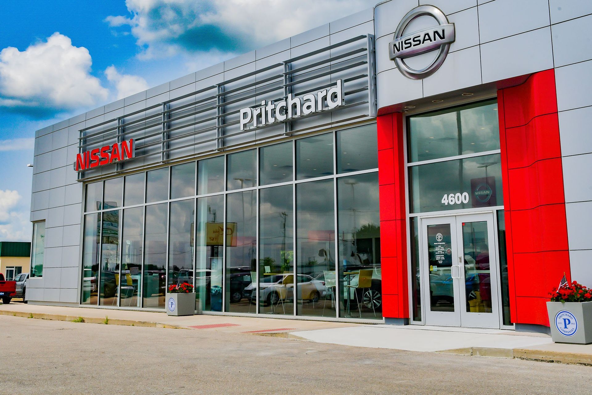 A nissan car dealership with a lot of windows