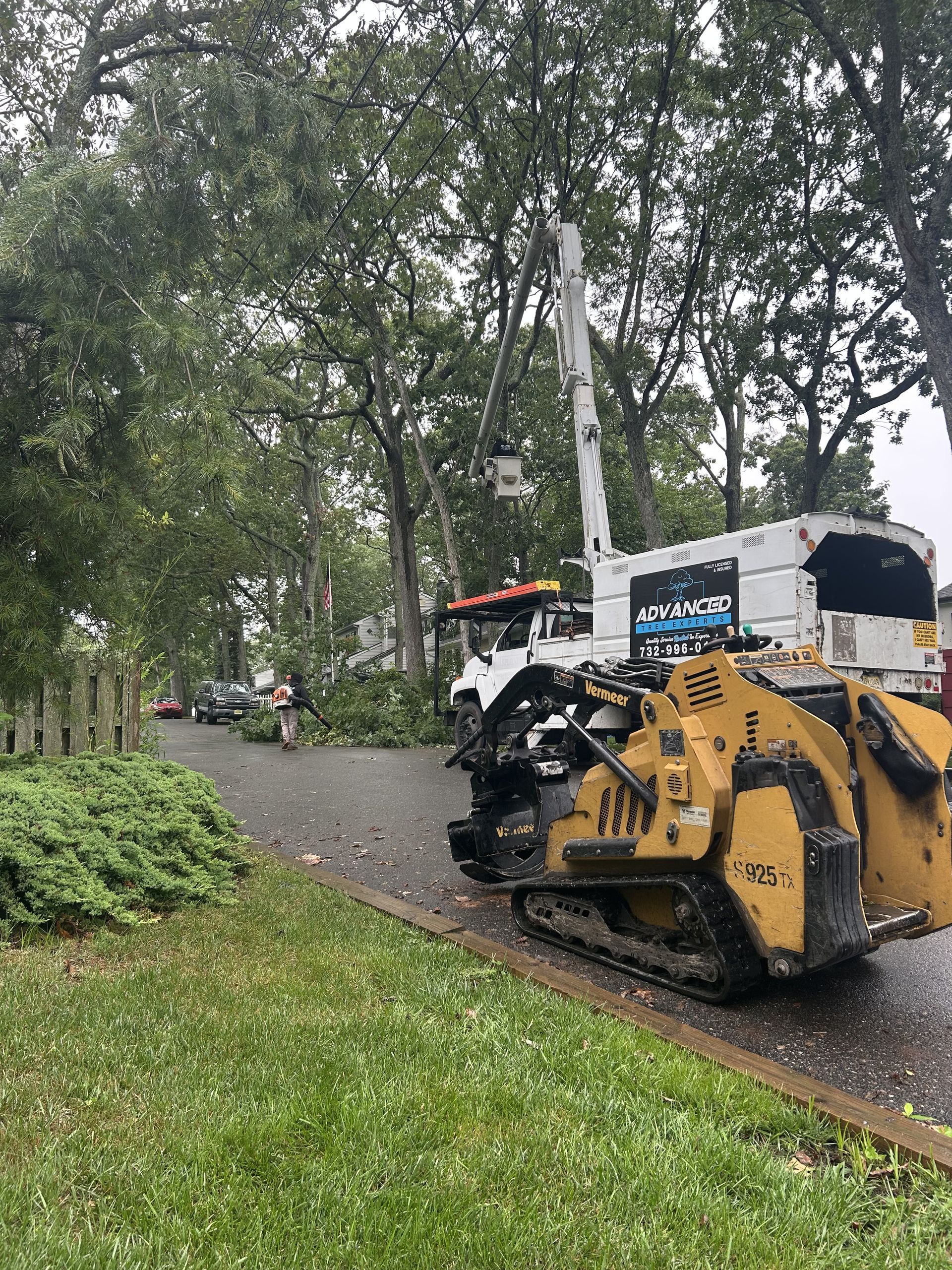A tree stump grinder is parked on the side of the road.