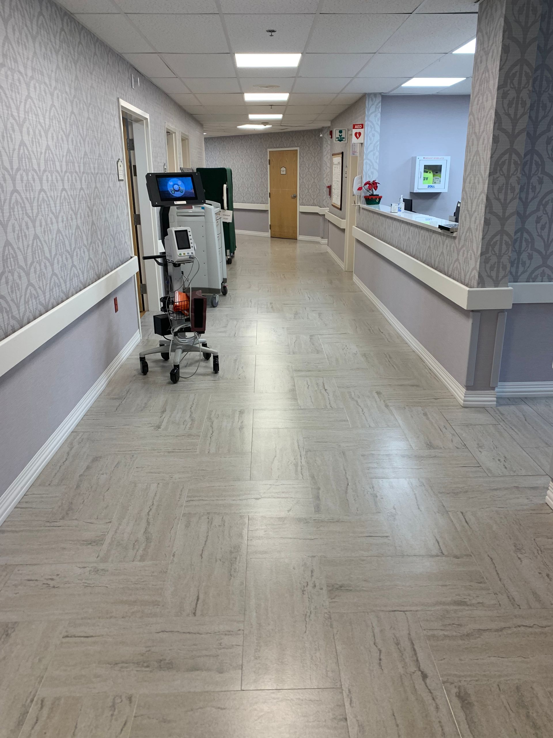 A hospital hallway with a trolley in the middle of it.