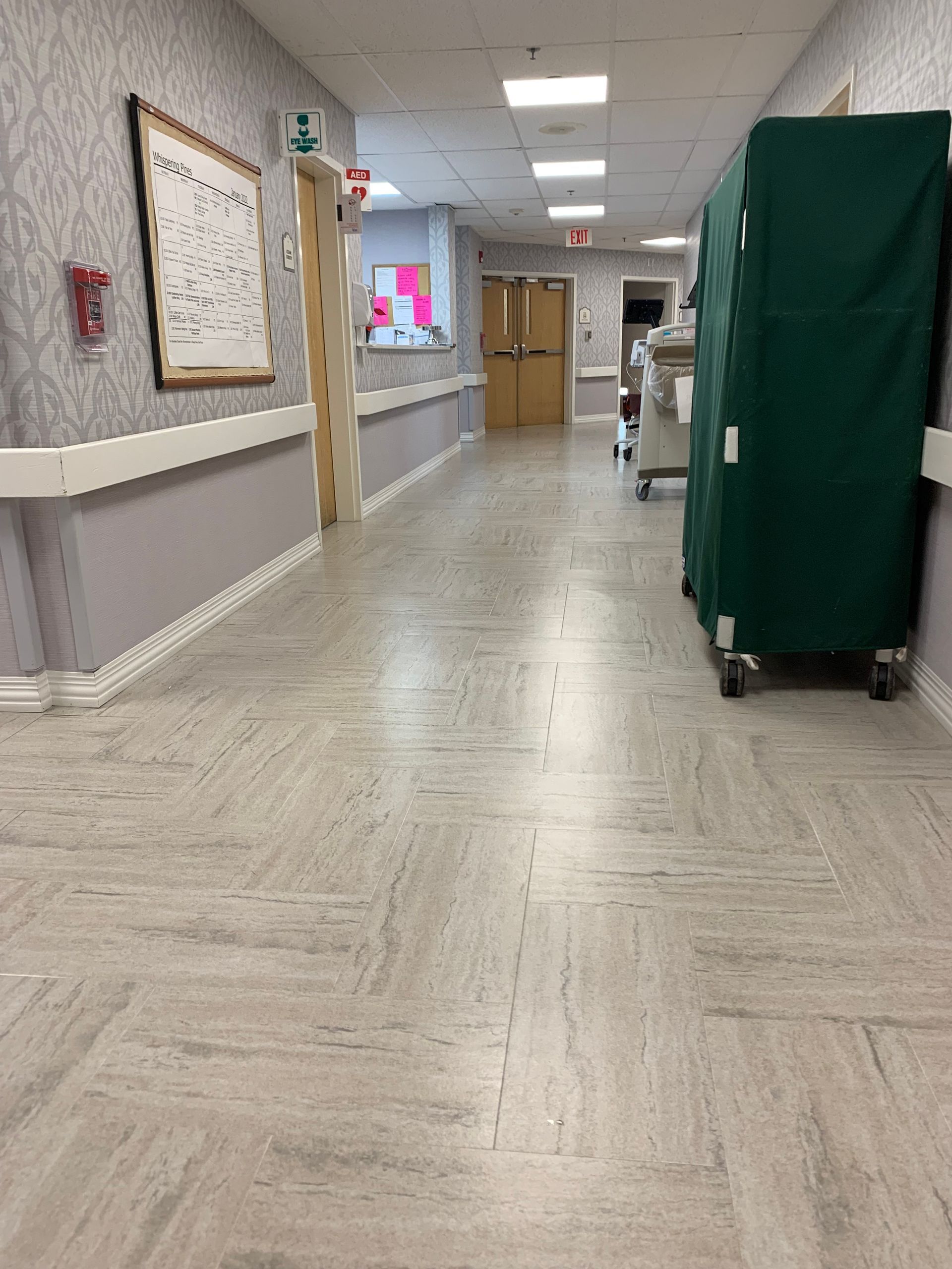 A hallway with a green cart in the middle