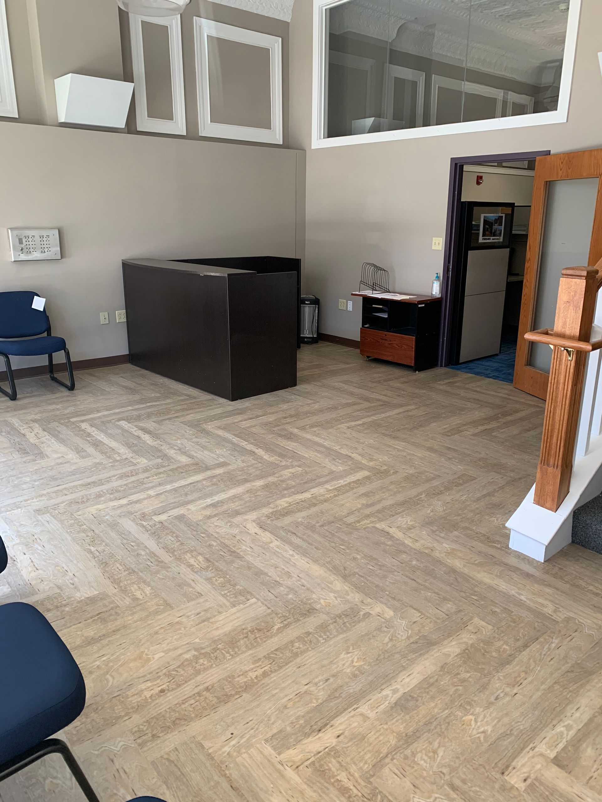 A large room with a wooden floor and a staircase