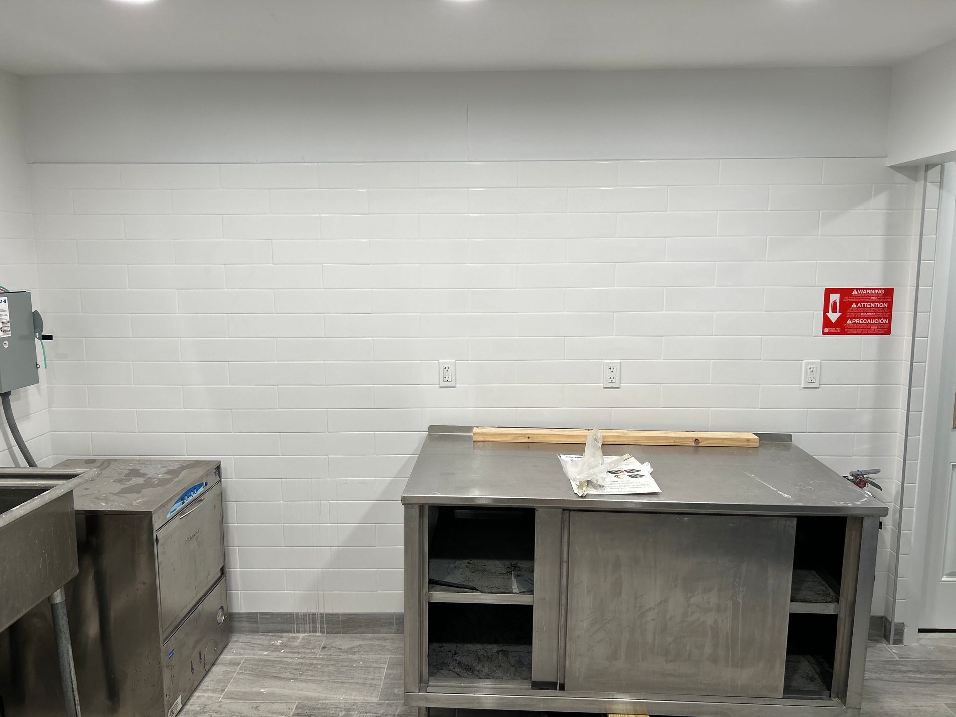 A kitchen with a stainless steel counter top and a sink