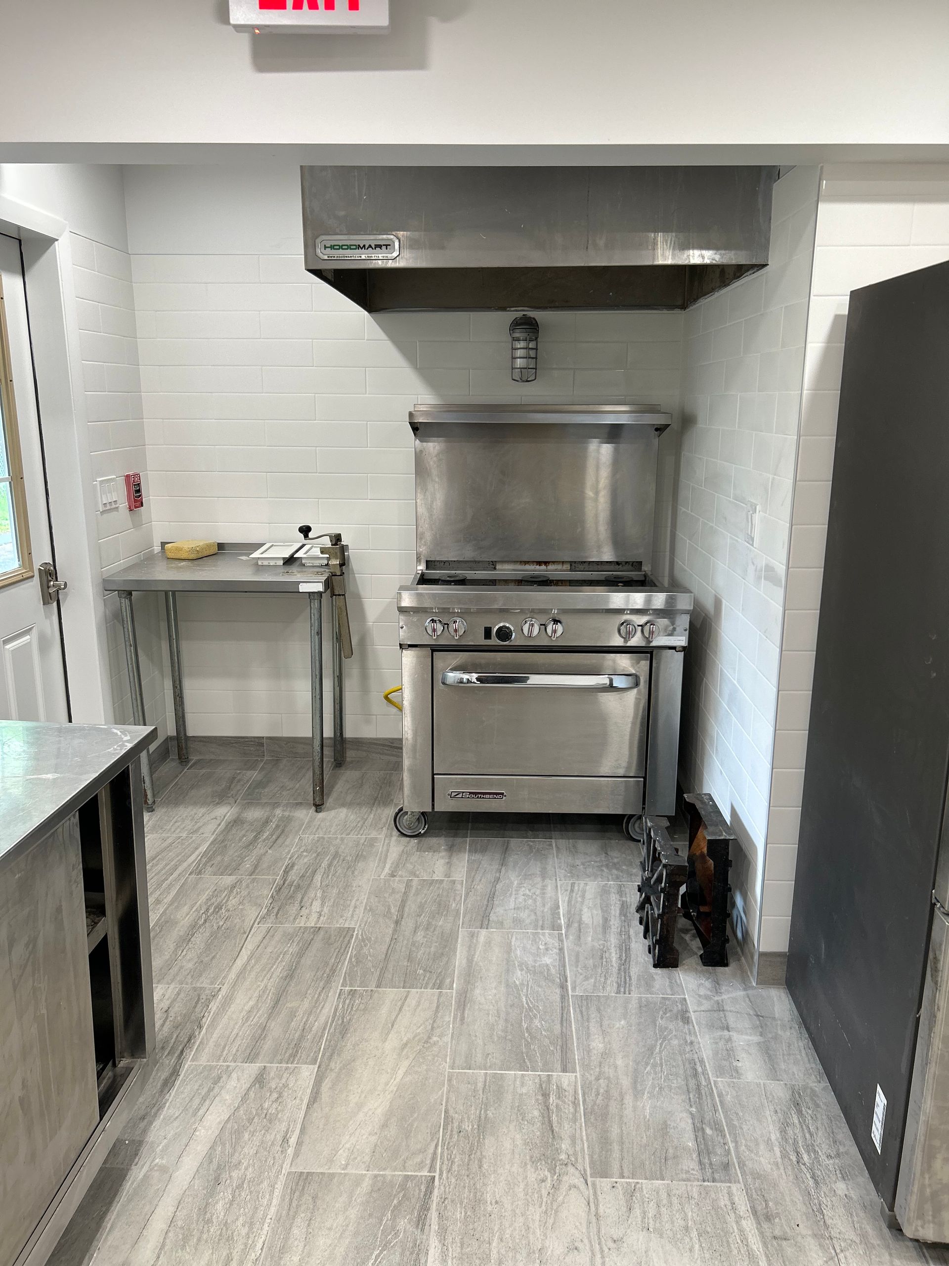 A kitchen with a stove and a sign that says exit