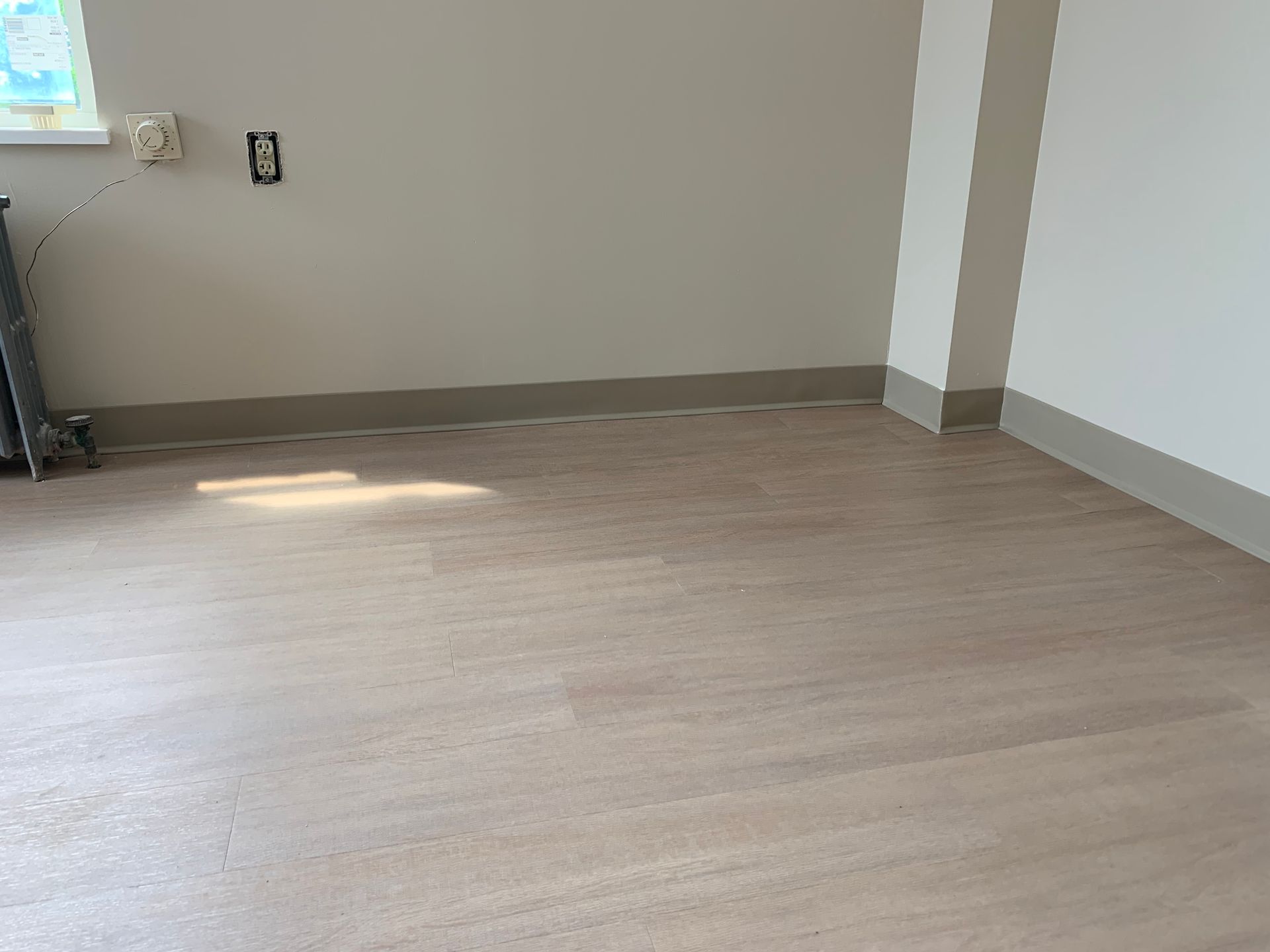 A room with a wooden floor and white walls