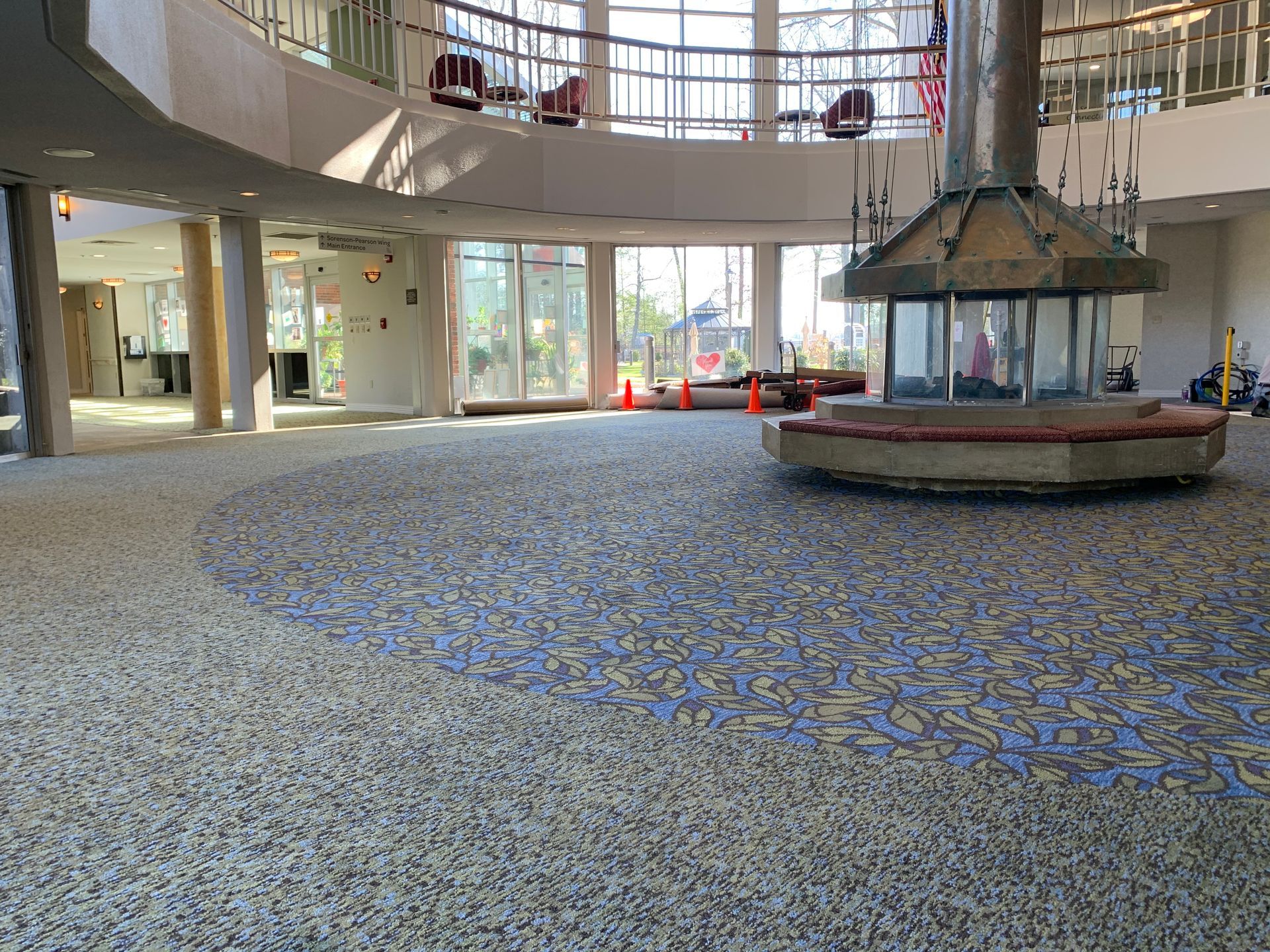 A large empty lobby with a fireplace in the middle