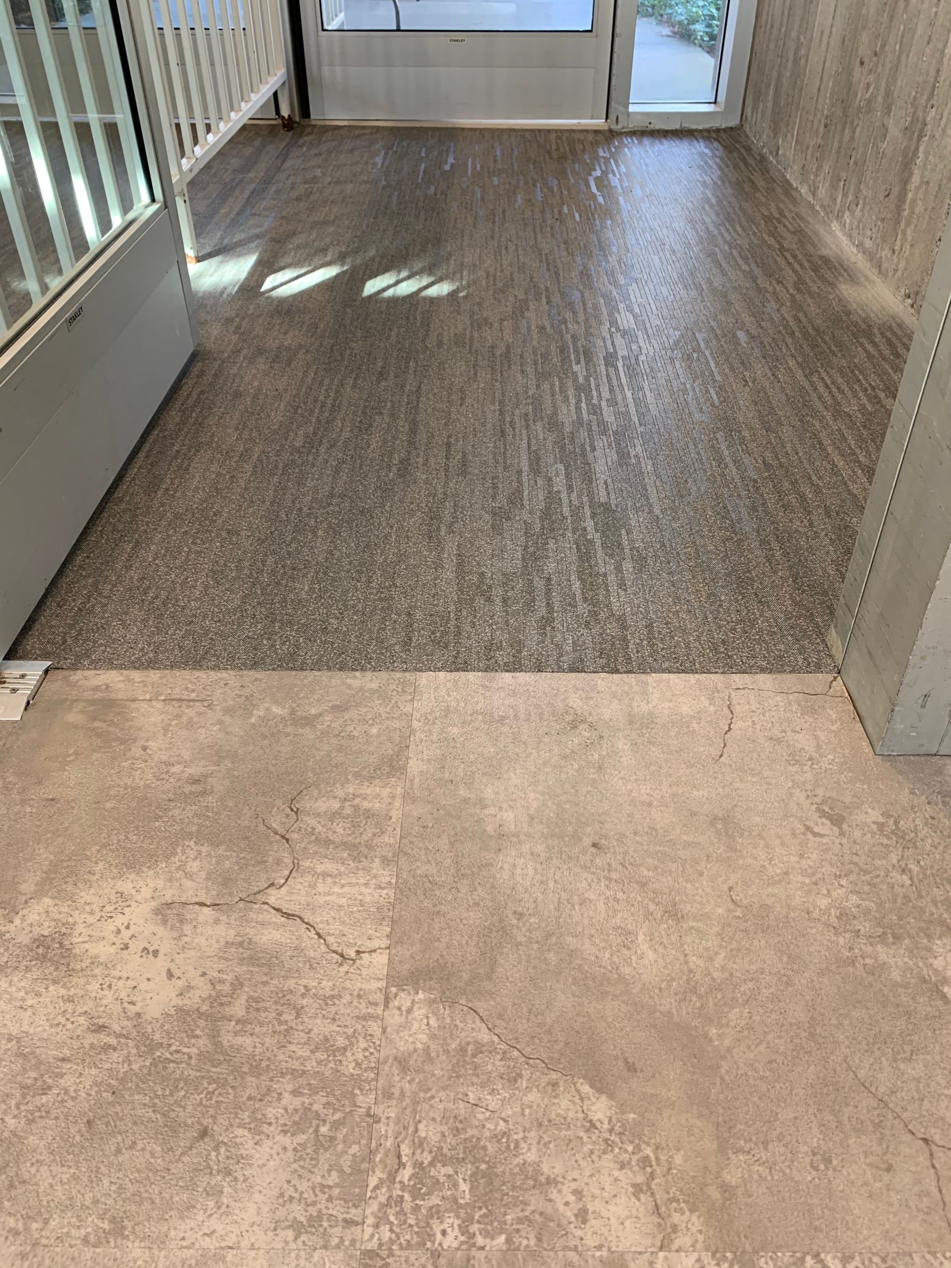 A concrete floor with a staircase in the background