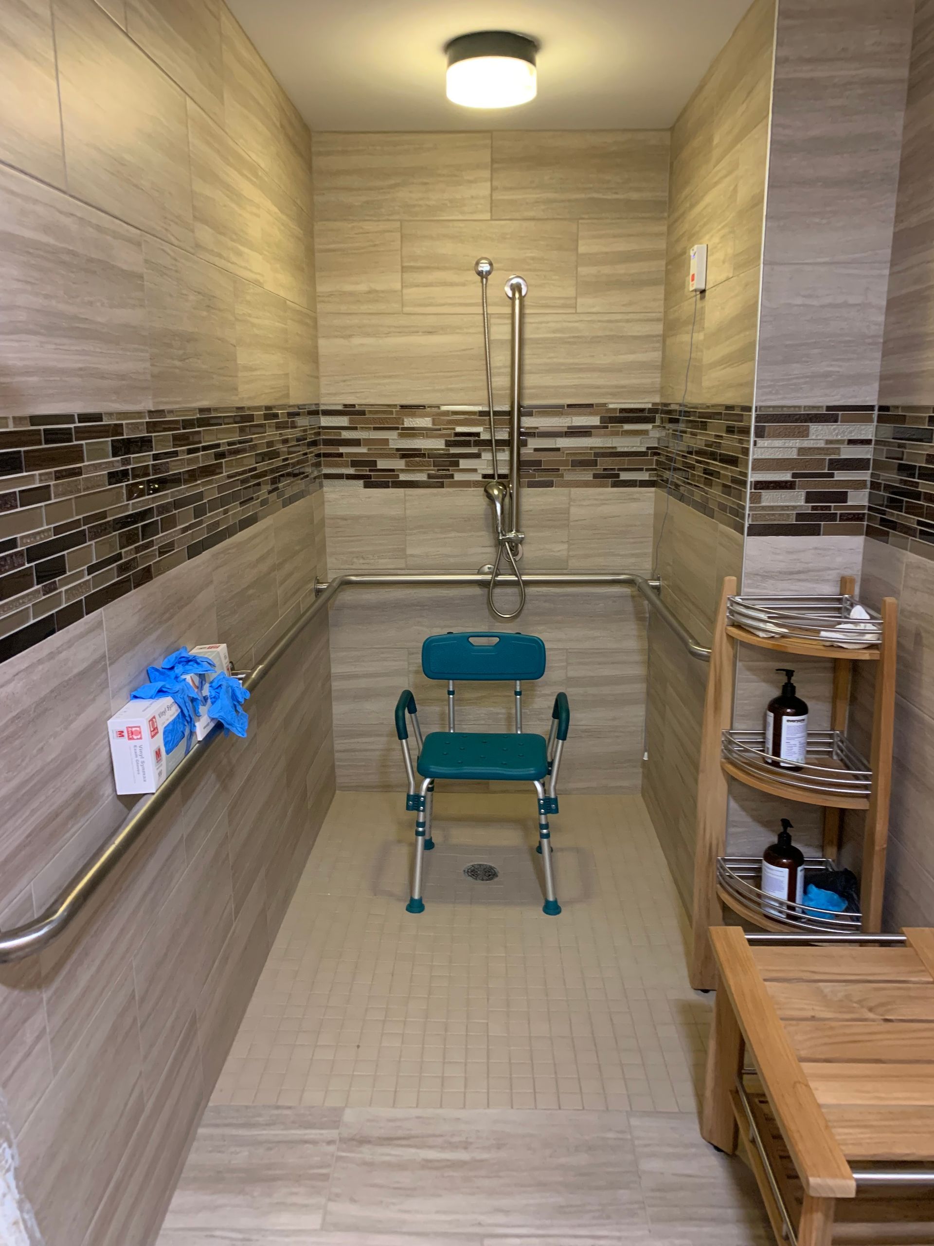 A handicapped shower with a chair in it