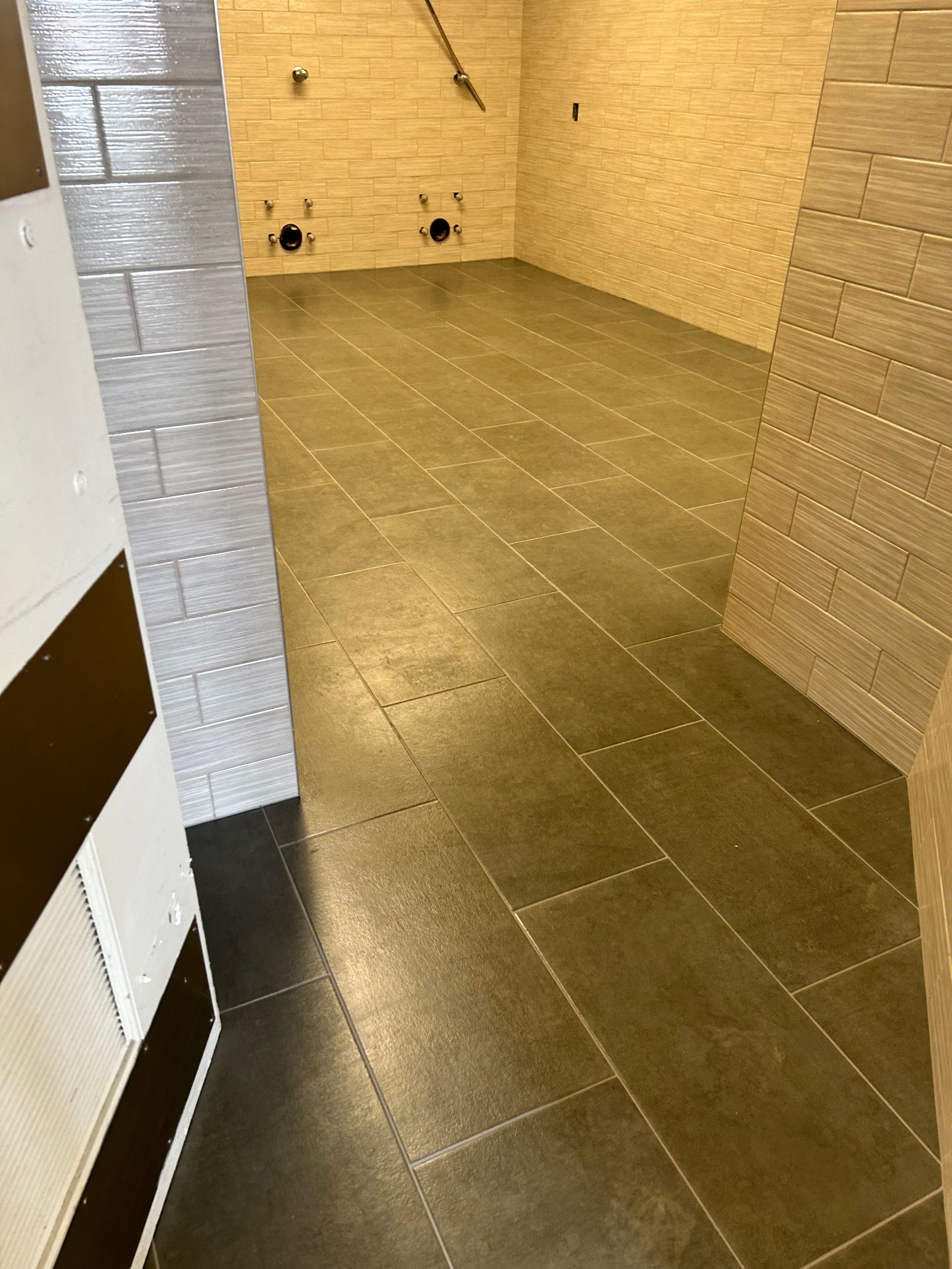 A room with a tiled floor and brick walls