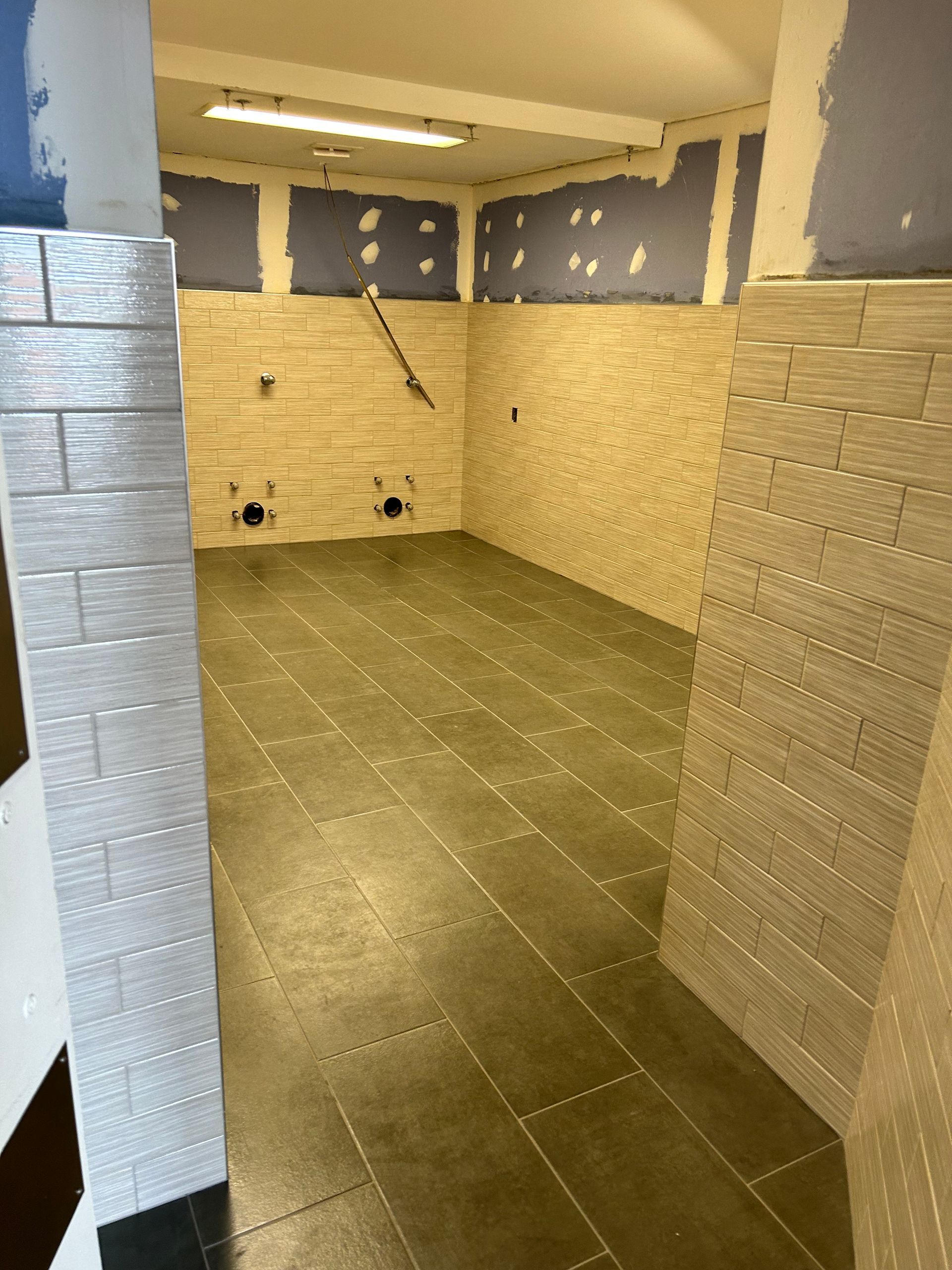 An empty room with brick walls and tile floors