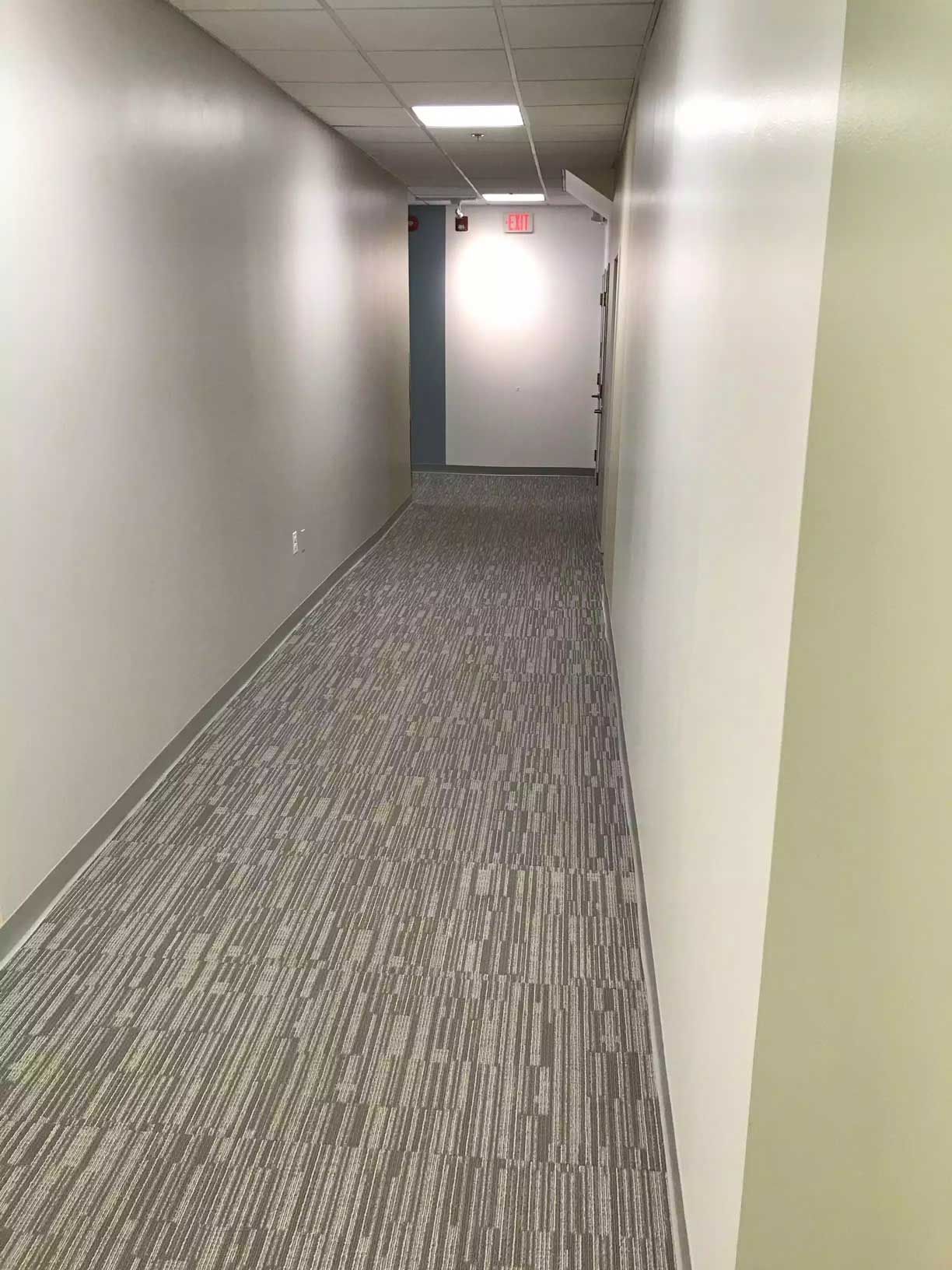 newly installed carpet along the corridor leading to the exit