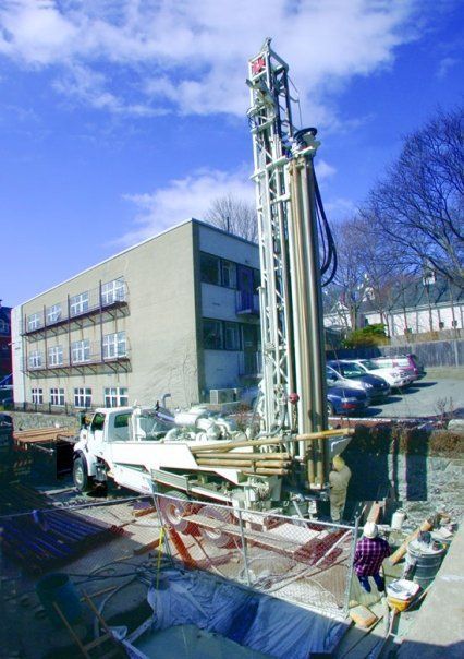 A large white truck is parked in front of a building