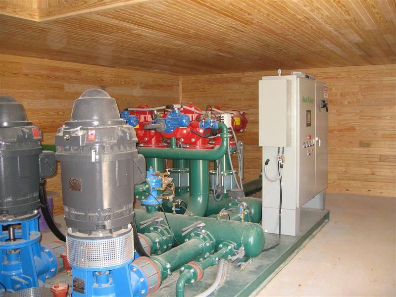 A room with a lot of pipes and pumps in it