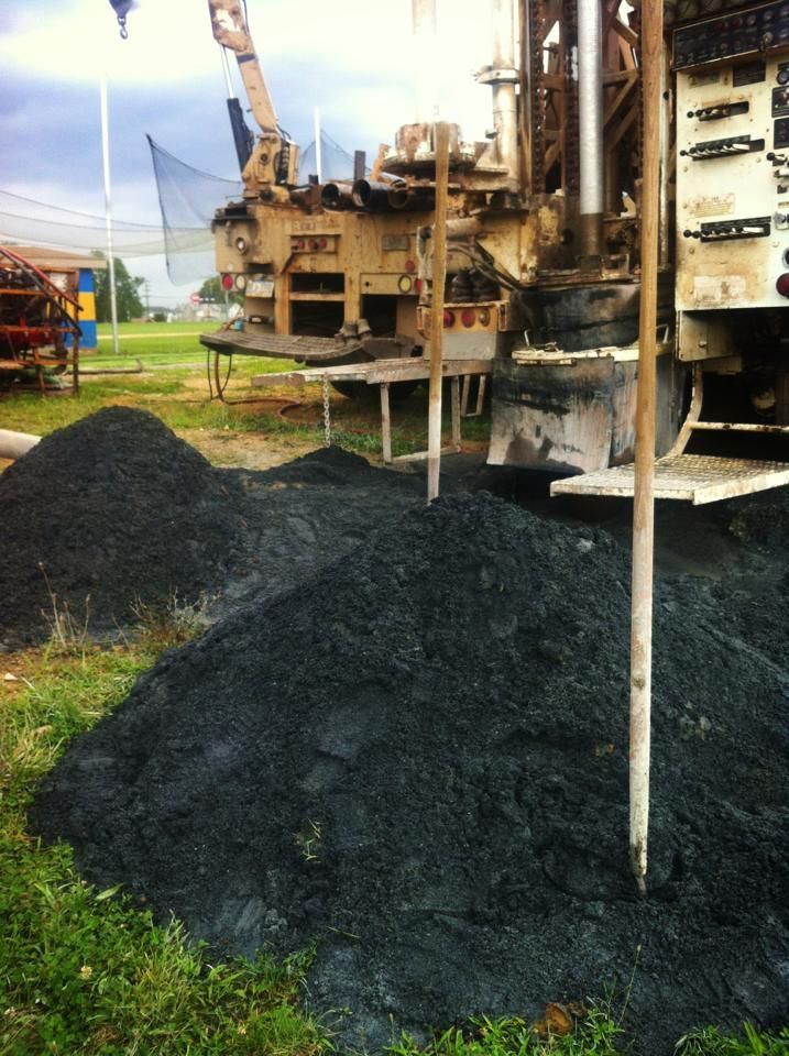 A pile of coal is sitting in front of a large machine