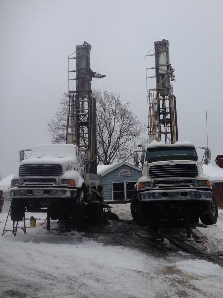 Two trucks are parked next to each other in the snow