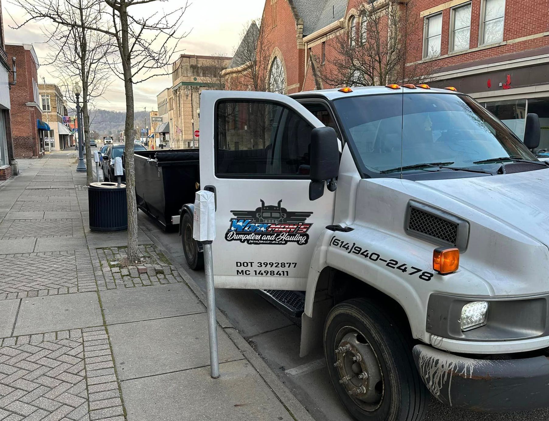 A white truck is parked on the side of the road.