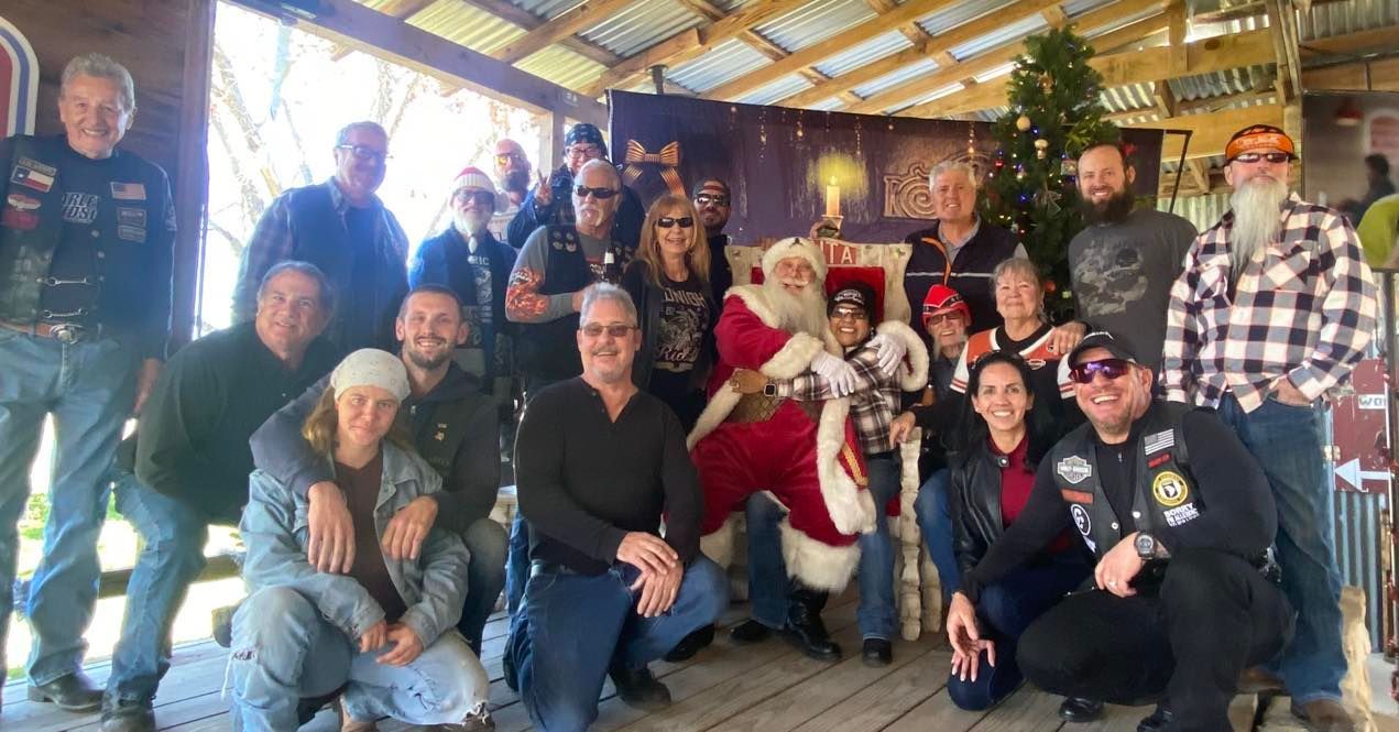 A group of people are posing for a picture with Santa Claus.