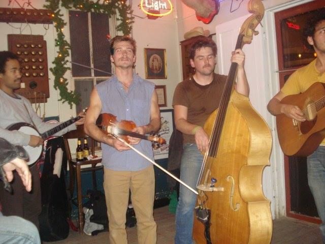A man playing a violin and a man playing a double bass.
