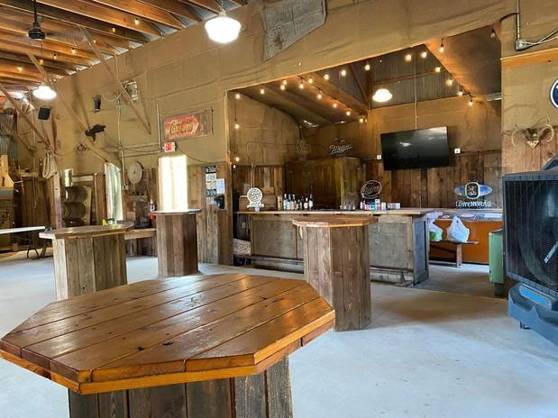 There are many wooden tables in the room.