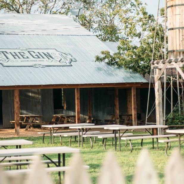 A barn with a sign that says the gin on it.