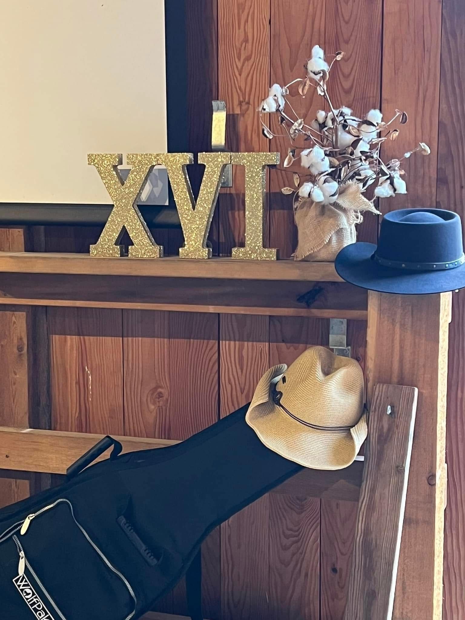 A cowboy hat is sitting on a wooden table.