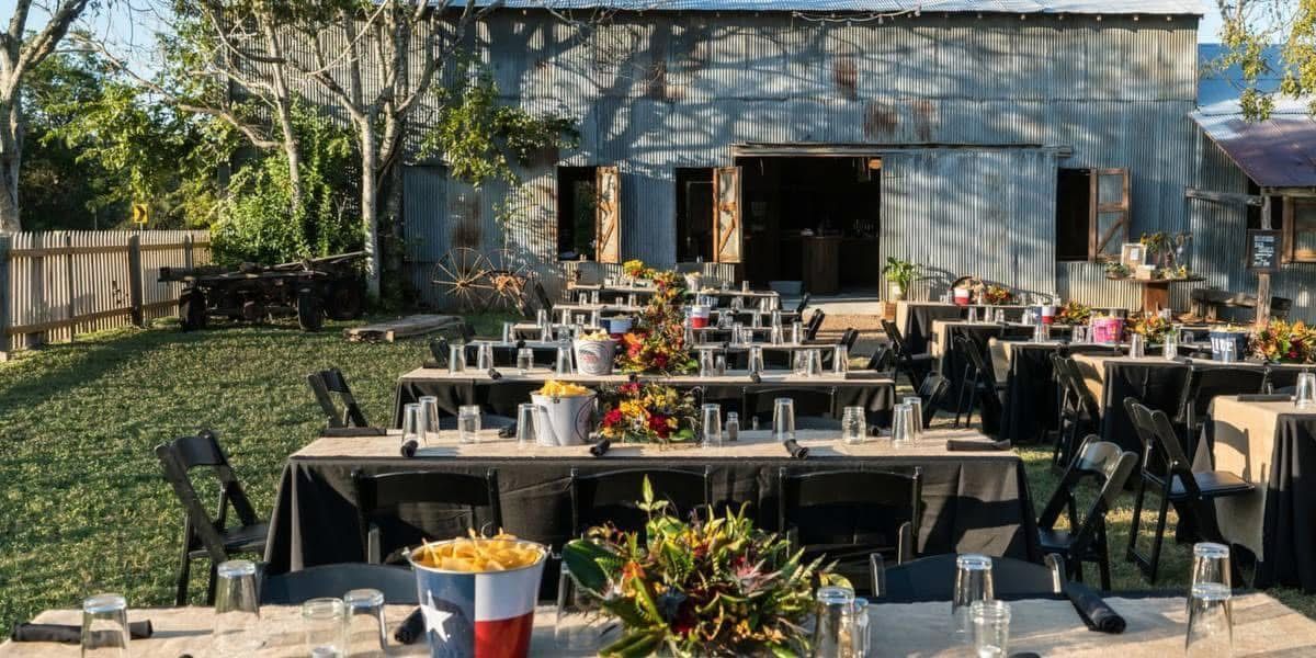A windmill and a water tower with a full moon in the background.