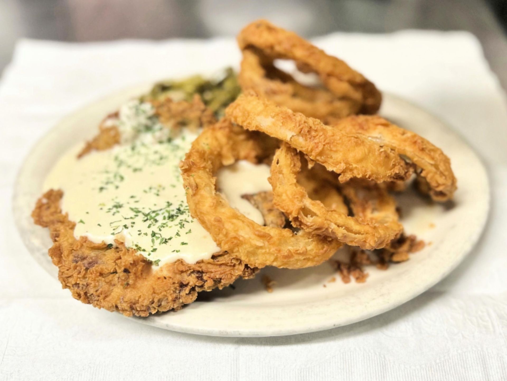 A hamburger and french fries on a plate on a table.