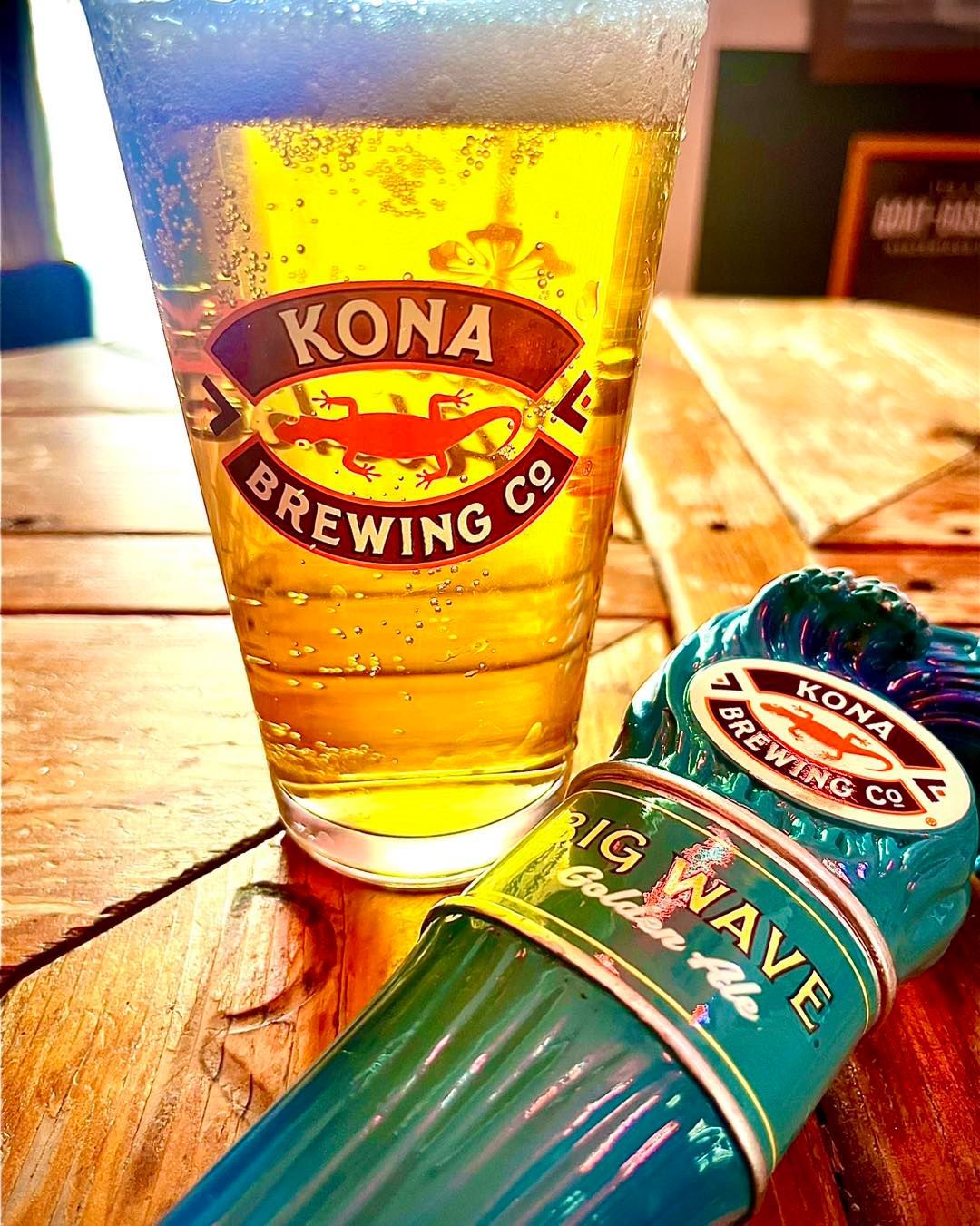 A glass of Kona Brewing Co. beer next to a bottle.