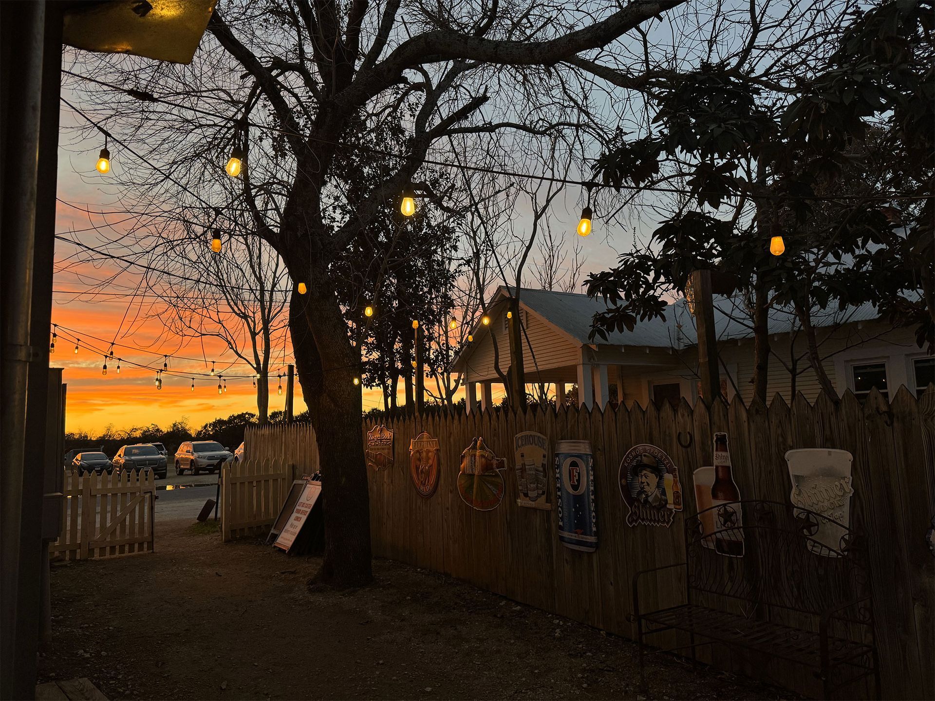 A wooden fence with a sunset in the background.
