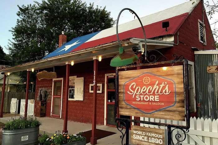 A red building with a sign that says Specht's store.