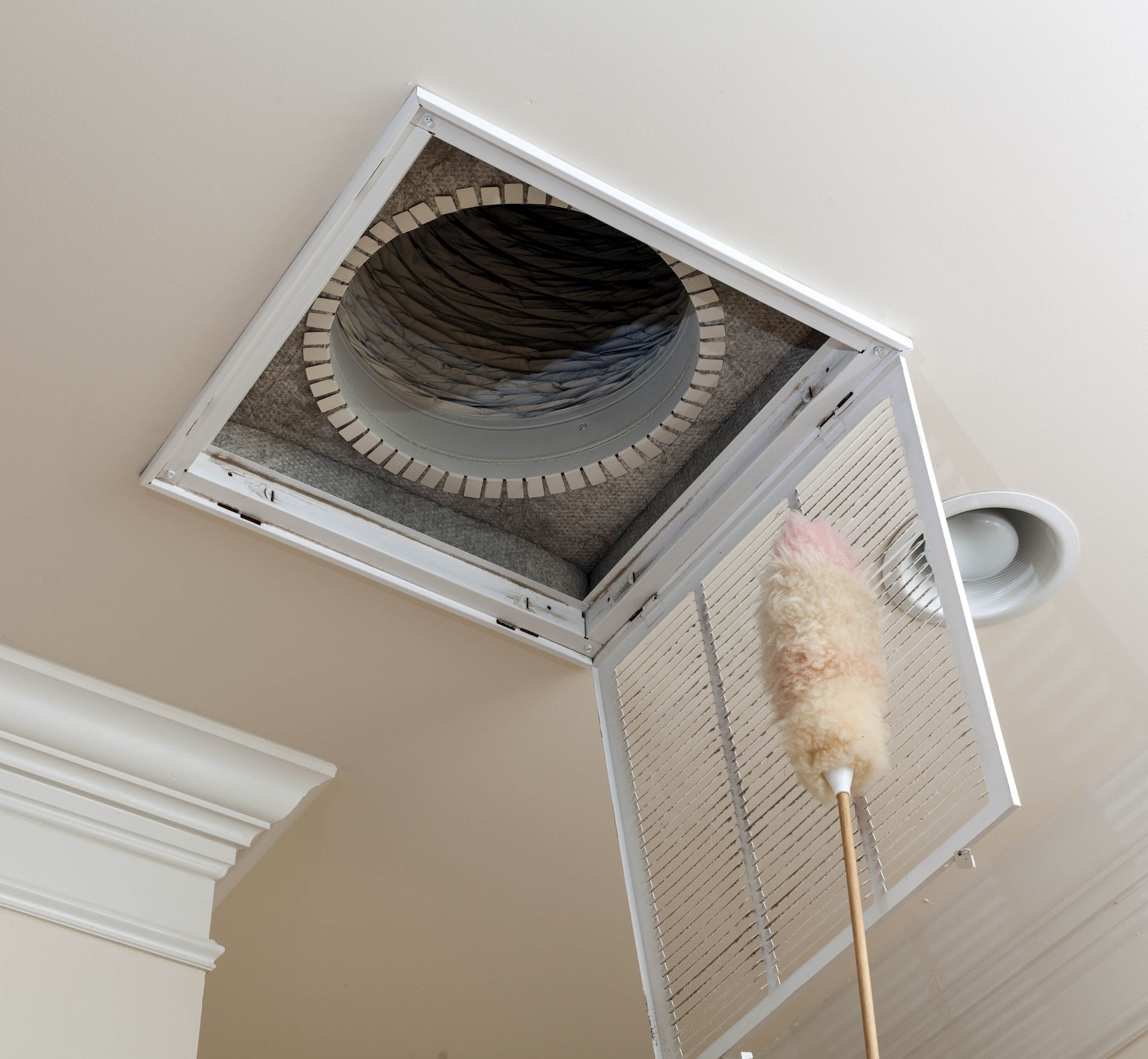 Open ceiling vent with a filter duster reaching up to it