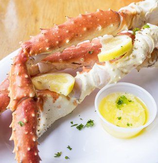 Crab Leg Cocktail with Cocktail Sauce and Lemons