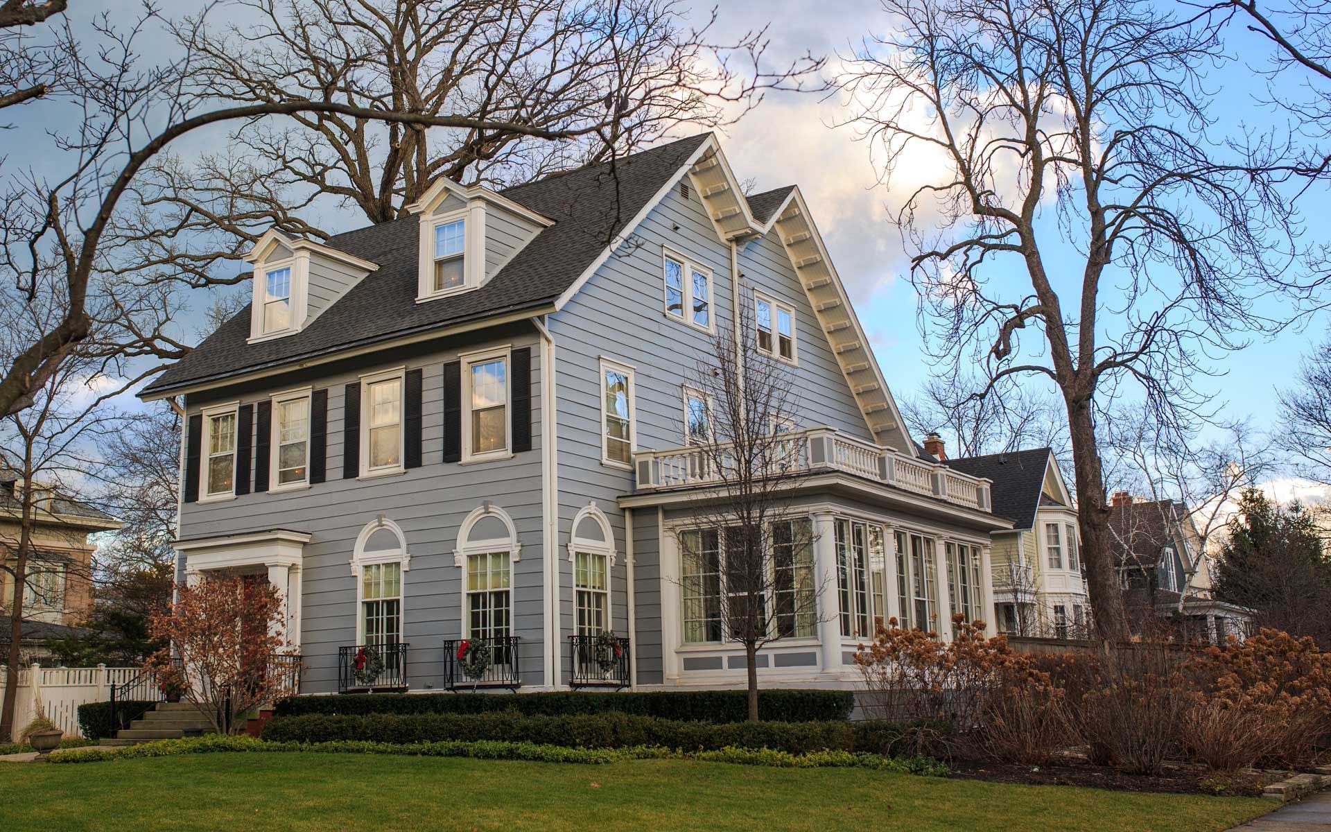 A large white house with black shutters on the windows