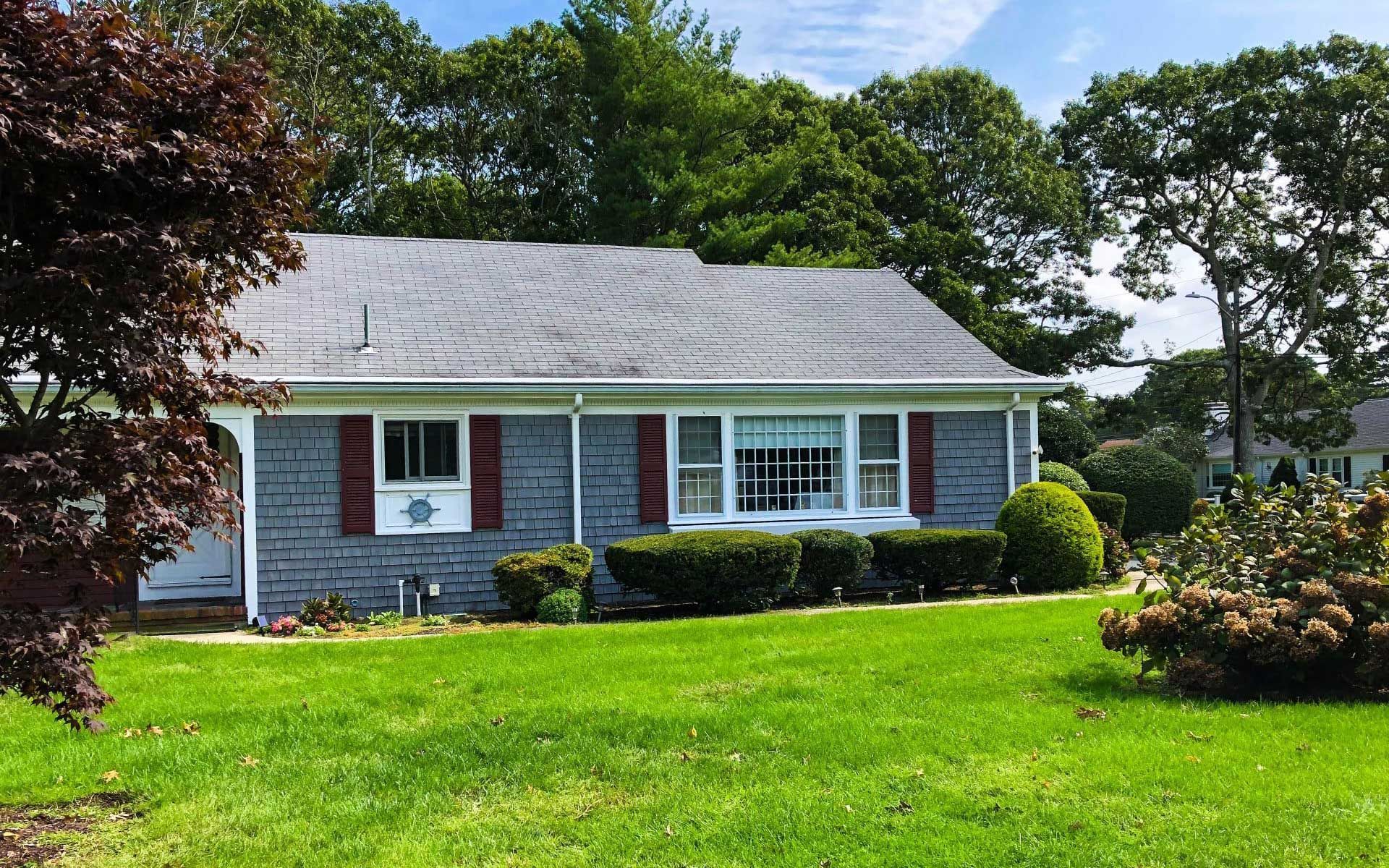 A house with a large lawn in front of it