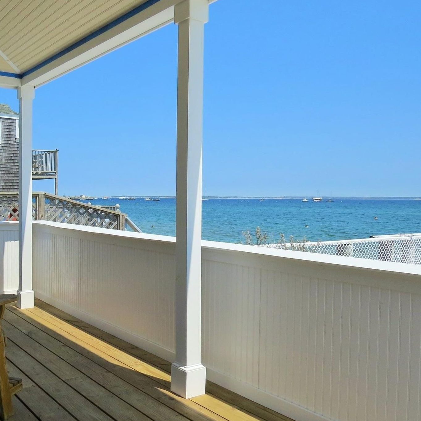 A balcony with a view of the ocean on a sunny day