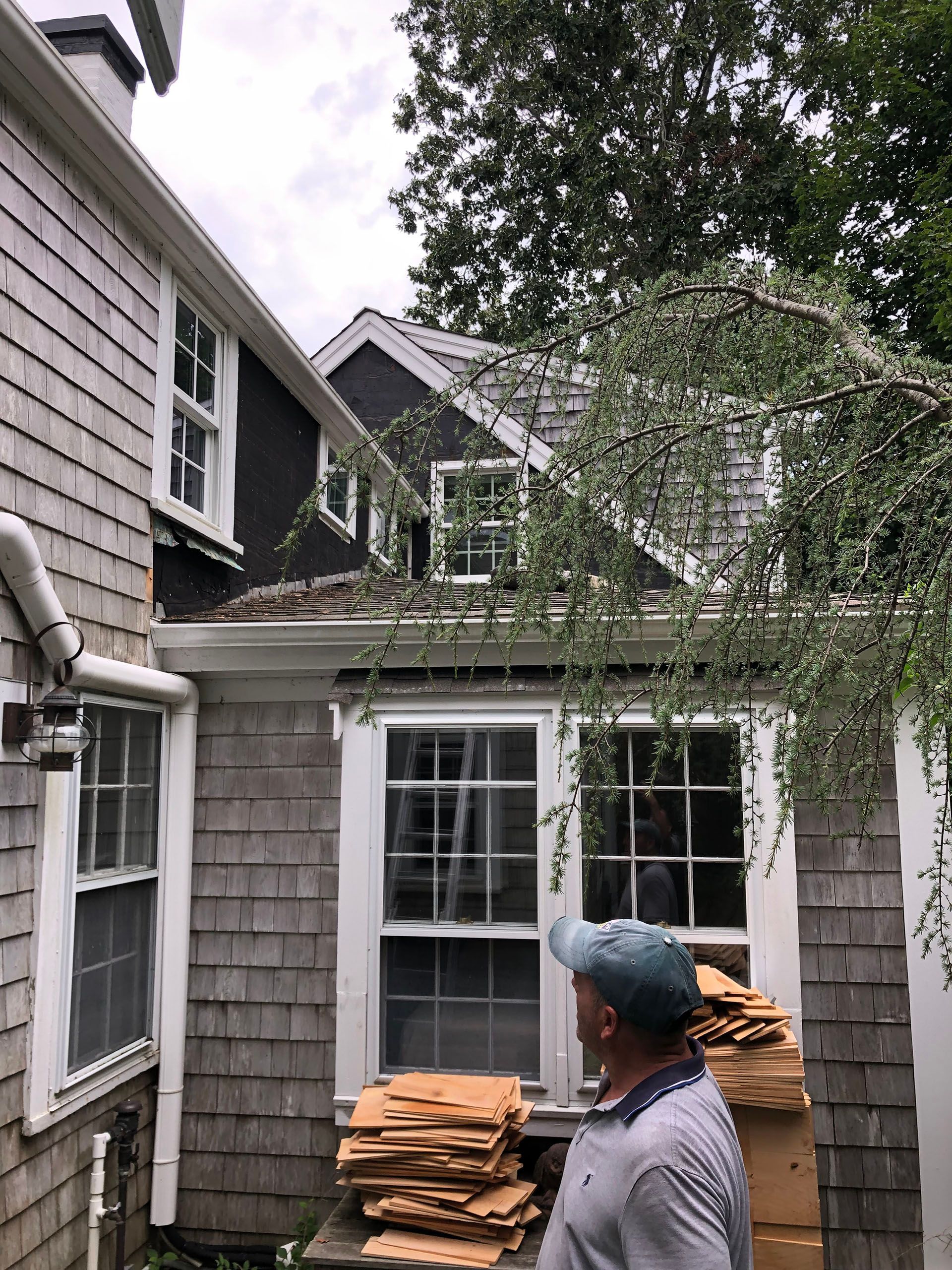A living room with a couch, chair, table, and ottoman.