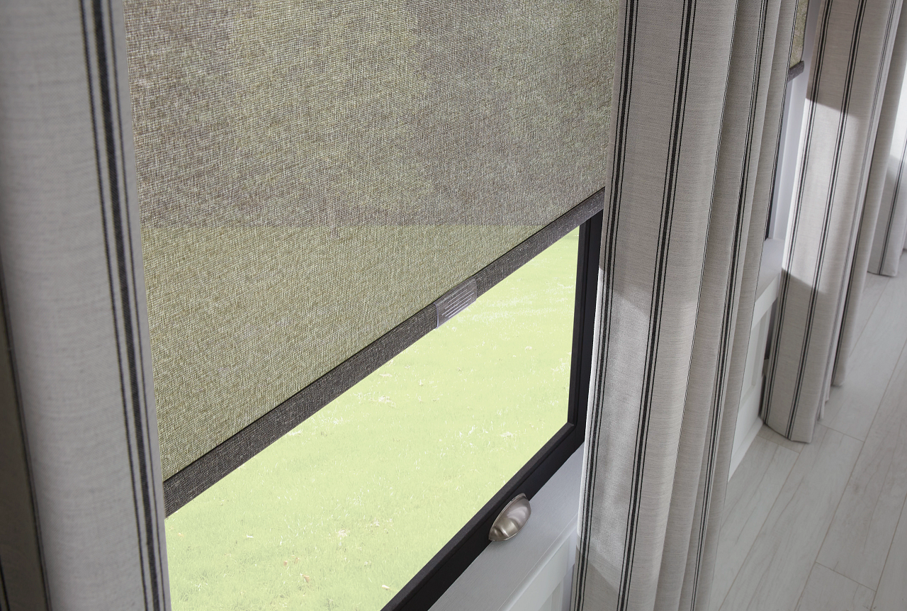 Interior view of a window with blinds and a partially open lower pane, showing green outdoors.