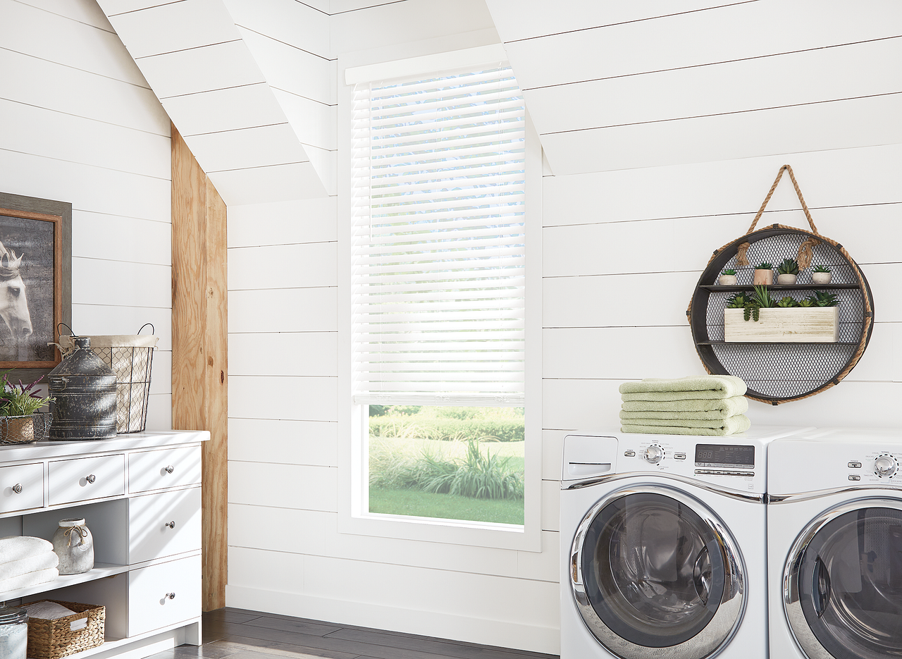 Laundry room with washer and dryer under a round mirror, white shiplap walls, and a window with blinds
