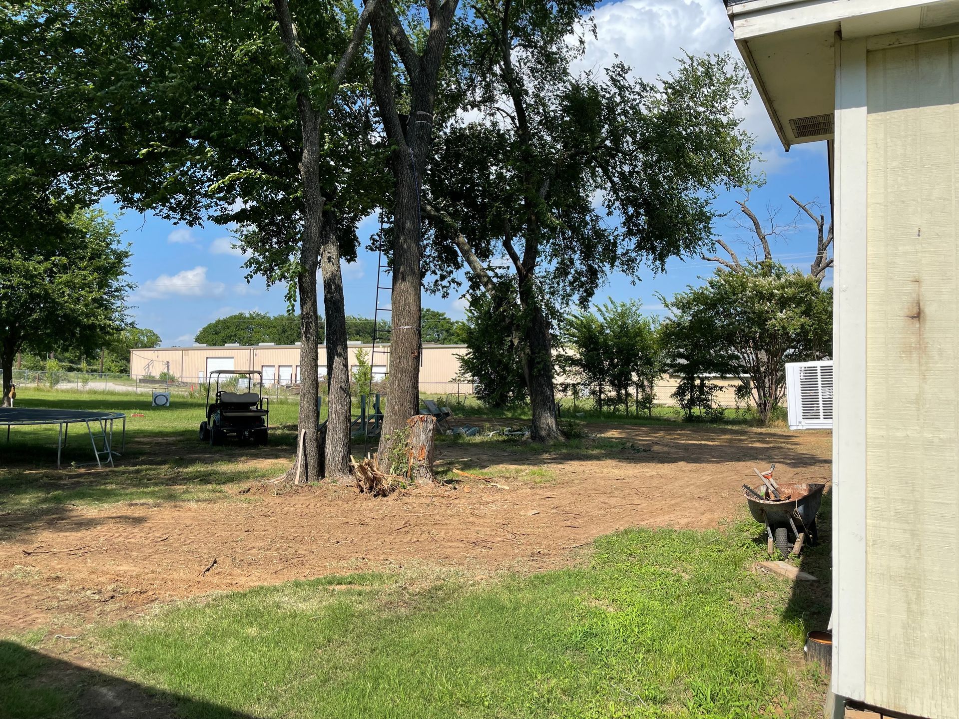 A house with a lot of grass and trees in front of it.
