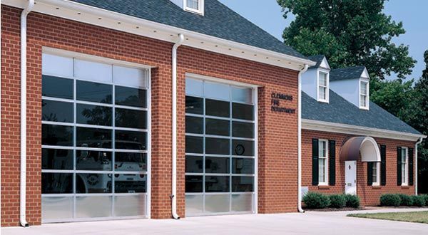 A red brick building with a large glass garage door