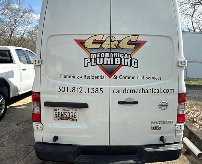 A white van with mechanical plumbing written on the back